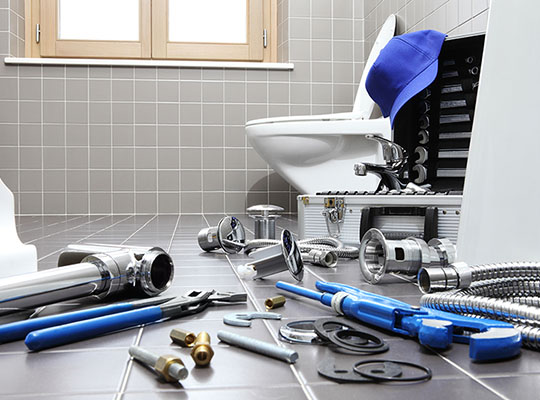 bathroom with white toilet and tools